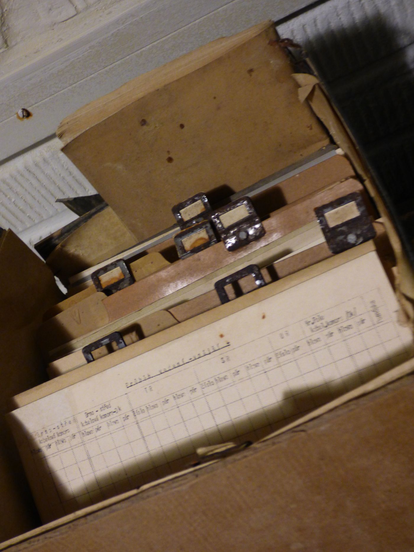 A box of archived papers with a handwritten ledger on top