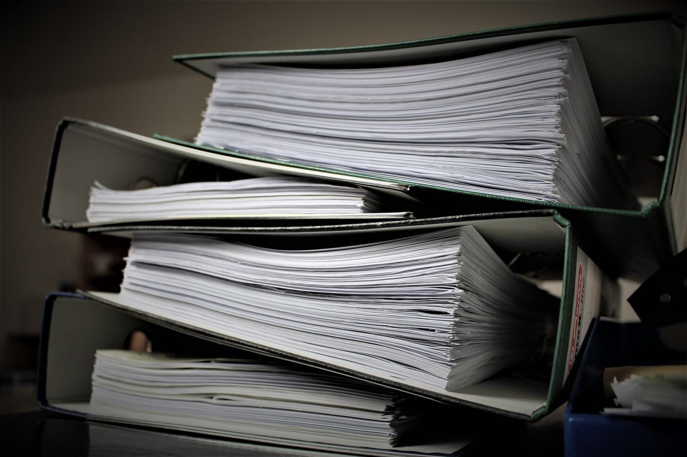 Stacked ring binders filled with documents
