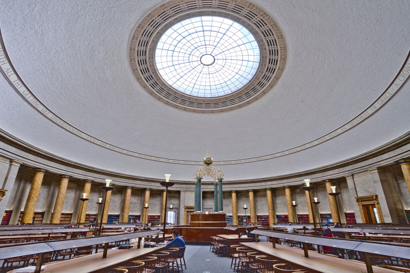 A domed reading room with stone columns and curved reading desks